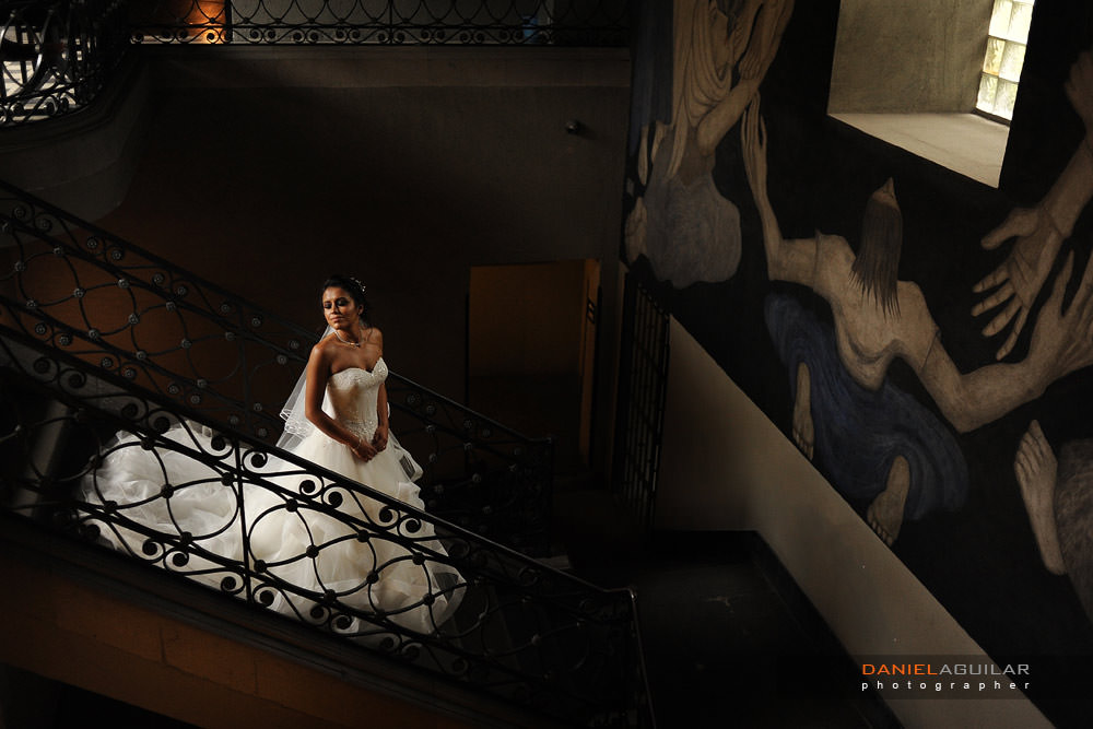bride is posing in the stairs with nice light in downtonw hotel mexico